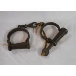 An old pair of iron handcuffs marked 623 to key and cuff - working order