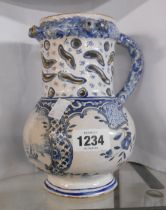 An antique delftware puzzle jug of tankard form with central panel, depicting a sailing boat on a