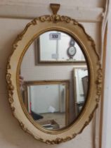 A modern Artware parcel gilt framed oval wall mirror with decorative border