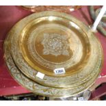 Five eastern brass trays with chased decoration - sold with another silver plated similar