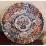 A large Japanese Imari charger with lobed rim and typical painted decoration