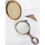 A heavy silver handled magnifying glass with initials - sold with a silver fronted oval photograph