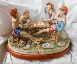A large vintage Capodimonte figure group 'The Cheats' designed by Cortese, set on wooden plinth with