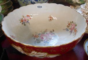 A large porcelain bowl with hand painted floral decoration