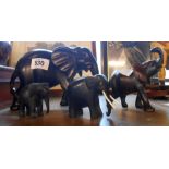 Three graduated carved ebony elephants - sold with another similar