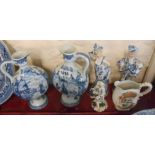 A pair of blue and white Delft pottery ewers of flattened moon flask form with typical