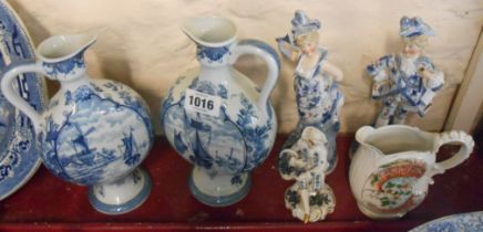 A pair of blue and white Delft pottery ewers of flattened moon flask form with typical