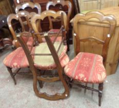 A set of six Victorian mahogany framed dining chairs with shaped top rails and upholstered seats,
