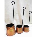 A set of three vintage copper cider measures