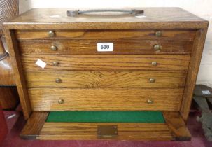 A vintage oak engineer's chest with removable front panel