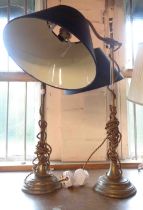 A pair of brass table lamps with black shades