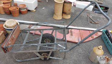 A large metal garden trolley of cage form