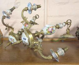 Two antique style painted porcelain and brass three branch candelabras