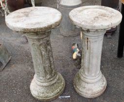 A pair of 72cm high concrete pedestals with fluted sides, set on circular bases