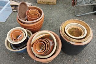 A large quantity of stoneware, glazed and terracotta garden plant pots