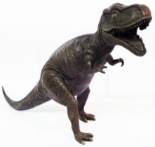 A modern bronzed dinosaur figure