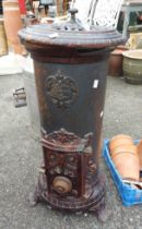 An old French cast iron stove in brown colourway - by Godin - lid broken at hinge but present