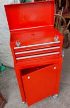 A red metal two tier roller tool chest with Halford socket set