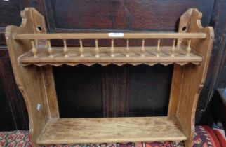 A 53cm mixed wood two shelf open unit with spindle gallery to top