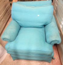 A 20th Century armchair with worn blue fitted upholstery and cushions