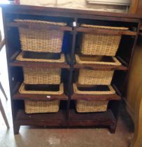 An 81cm stained wood storage unit with six slides containing wicker baskets, set on raised feet