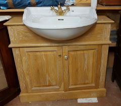 A 94cm modern limed oak vanity unit with central mirror and flanking cupboards to top, over a base