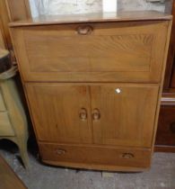 An 82.5cm vintage Ercol 'Windsor' light elm cocktail cabinet with fall-front compartment, pair of