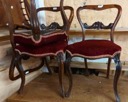 A set of four Victorian rosewood framed balloon back dining chairs with piped red velour upholstered