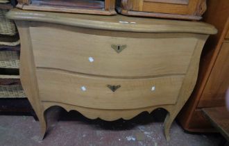 A 1.04m French oak antique style serpentine front bombe chest of two long drawers, set on shaped