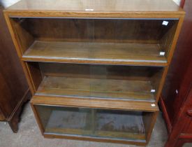 An 89cm vintage Minty oak three section modular bookcase enclosed by glass sliding doors