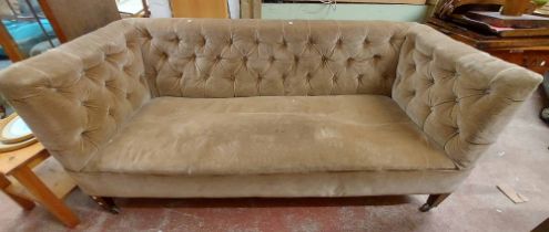 A 1.8m antique box frame settee with button back mushroom coloured velour upholstery, set on