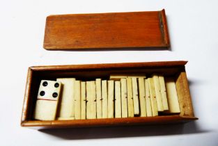 A boxed set of antique miniature bone dominoes