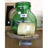 A small green glass carboy - sold with a model ship made from cow horn