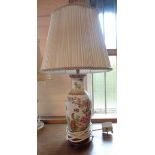 A Chinese style porcelain table lamp with transfer printed decoration and hand painted highlighting