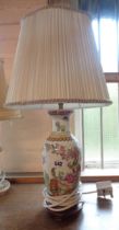 A Chinese style porcelain table lamp with transfer printed decoration and hand painted highlighting