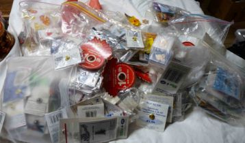 A bag containing a large collection of charity and other badges