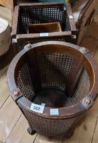 Two vintage stained oak and rattan wastepaper baskets - sold with another with incised and