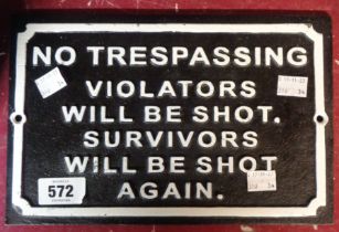 A modern painted cast iron 'Trespass' sign