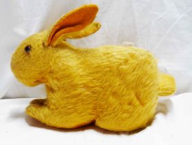 A vintage straw filled rabbit toy with turning musical movement tail (not working)