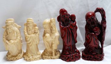 A pair of Chinese resin figurines with red finish - sold with three ivory coloured similar