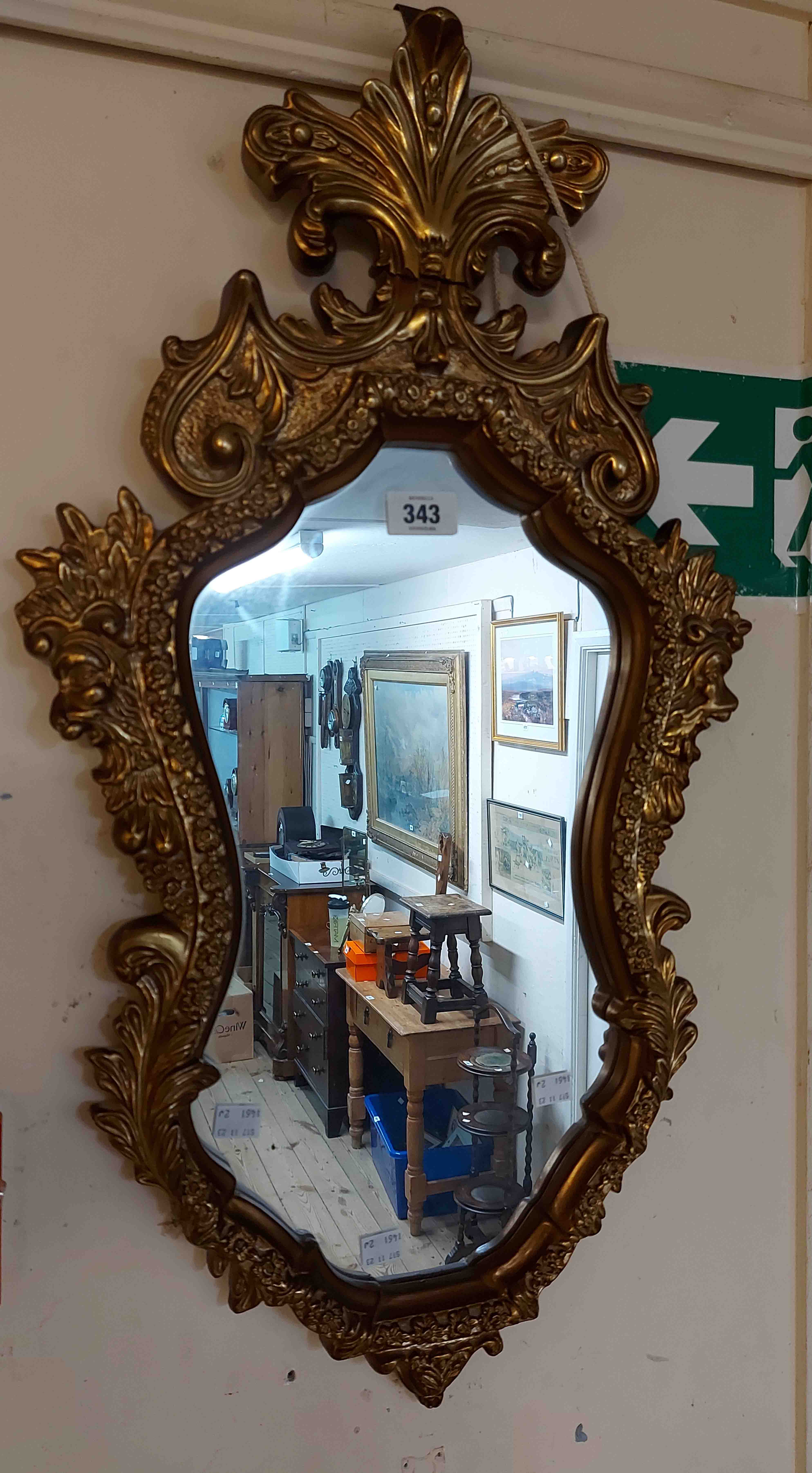 A vintage ornate gilt resin framed wall mirror with shaped plate - strap repair to pediment