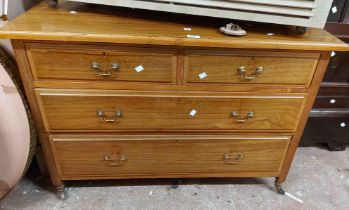 A 1.07m 20th Century walnut and strung chest of two short and two long drawers, set on casters