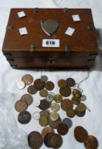 A small decorative metal bound oak box containing a small quantity of vintage coins