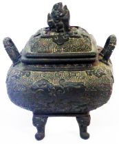A small antique Chinese bronze censer of square form with four mask feat, the body moulded with