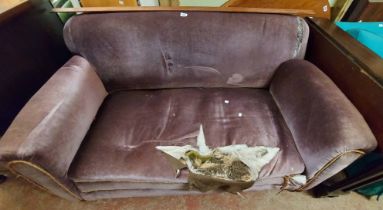 A 1.5m old drop-end settee with remains purple velour upholstery - sold with a drawing room armchair