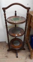 A 1920's stained oak three tier cake stand with bobbin turned supports