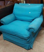 A 20th Century armchair with worn blue fitted upholstery and cushions