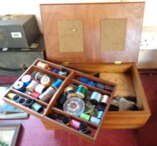 A vintage small tabletop lift-top sewing box and contents