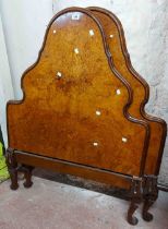 A pair of 1930's walnut veneered single bedsteads with shaped headboards, wooden side rails