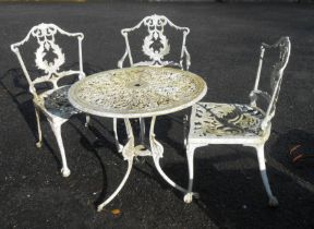 A white painted cast aluminium garden table in the antique style - sold with three chairs to match